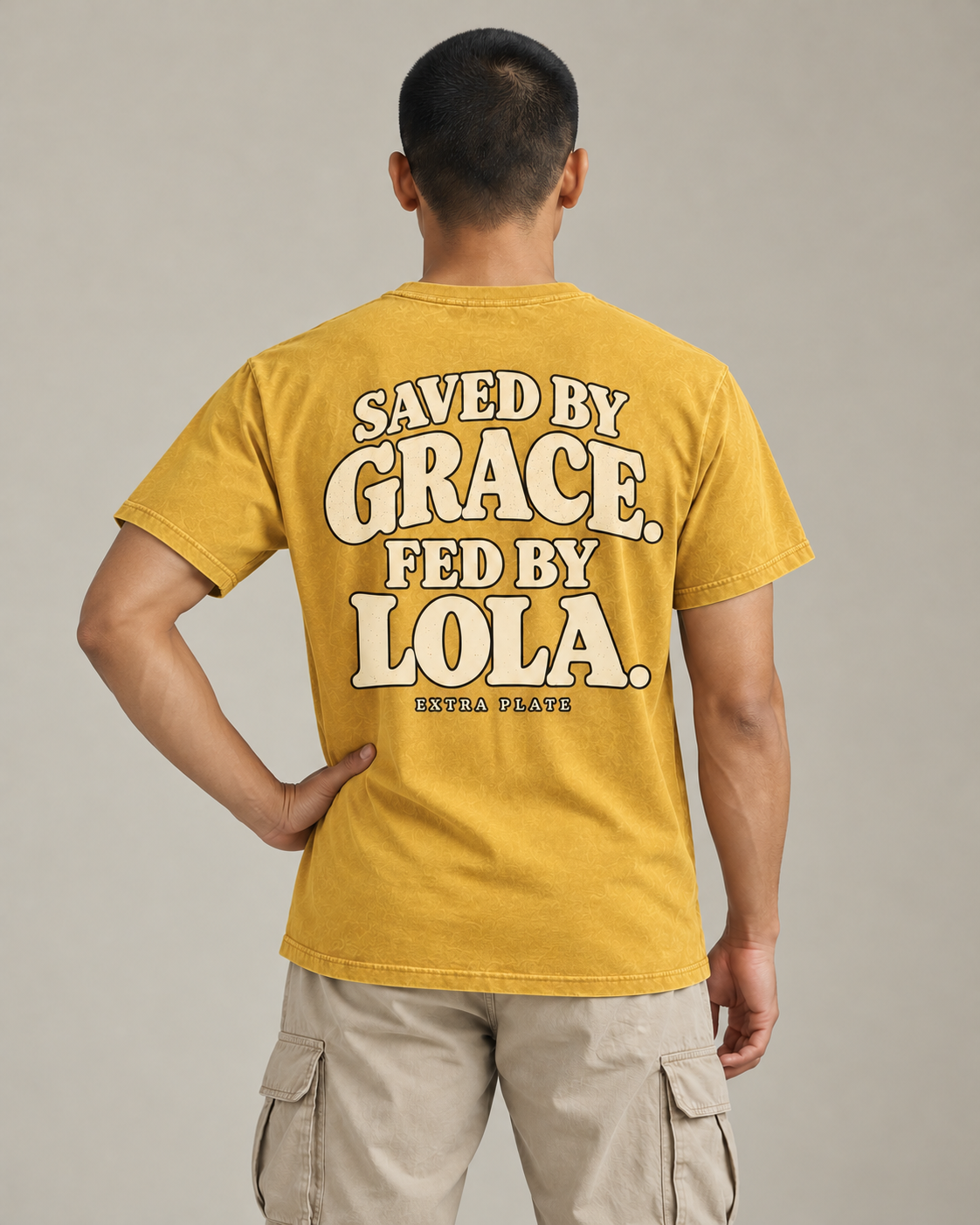 Saved by Grace. Fed by Lola. Tee in faded-mustard — model back view