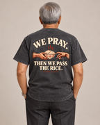 We Pray. Then We Pass the Rice. Tee in Uling Black — model back view